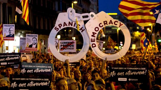 Pro-independence demonstrators gather to mark one year of the Spanish police raid and protest which lead to the imprisonment of the leaders of Catalonia's main pro-independence movements in Barcelona