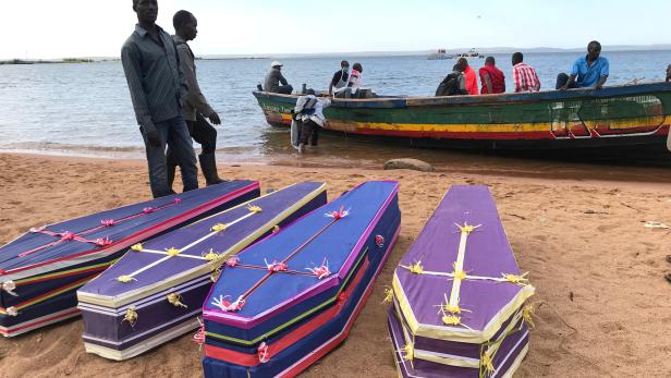 Volunteers arrange the coffins containing the dead bodies of passengers retrieved after a ferry MV Nyerere overturned off the shores of Ukara Island in Lake Victoria