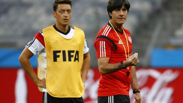 Germany's national soccer team player Oezil and team coach Loew  attend a training session in Belo Horizonte