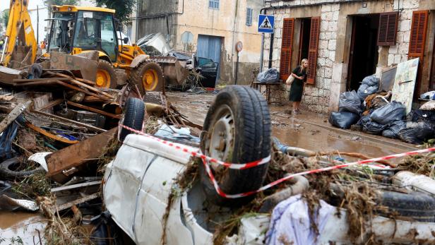 A resident walks through debris as heavy rain and flash floods hit Sant Llorenc de Cardassar on the island of Mallorca