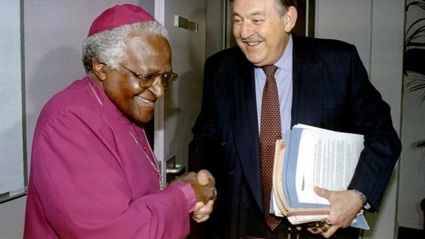 FILE PHOTO: Former South African Foreign Minister Pik Botha shakes hands with Archbishop Desmond Tutu  at the Truth and Reconciliation Commission (TRC) in Johannesburg