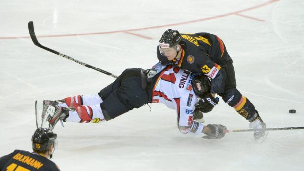 epa03577472 Matthias Trattnig of Austria (L) and Felix Petermann (R) of Germany vie for the puck, during the IIHF ice hockey Olympics qualification match between Germany and Austria in Bietigheim-Bissingen, Germany, 10 February 2013. EPA/MARIJAN MURAT