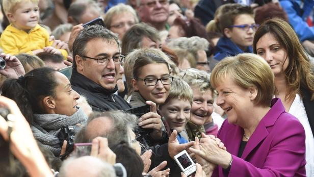German Chancellor Merkel greets the public during