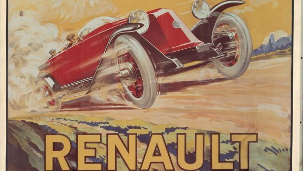 Ein roter Renault rast auf einer sandigen Straße.