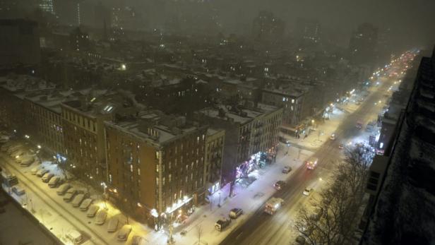 Blick auf eine verschneite New Yorker Straße bei Nacht.