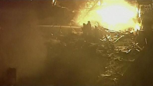 Aerial of the flames and firefighters working at t