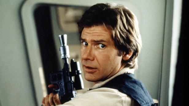 Harrison Ford als Han Solo mit einer Waffe in der Hand.