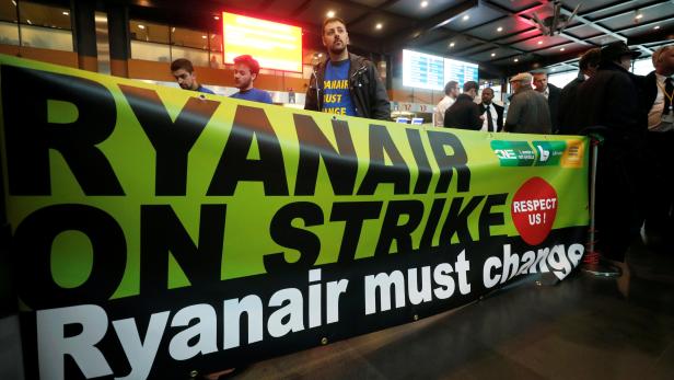 FILE PHOTO: Belgian Ryanair pilots and crew members take part in a protest during a wider European strike at the airline to protest slow progress in negotiating a collective labour agreement, at Brussels South Charleroi Airport