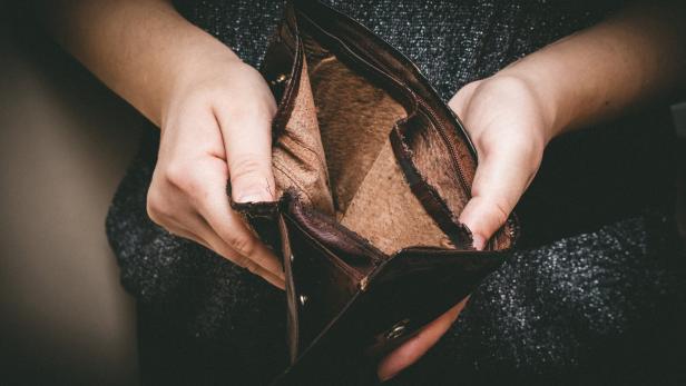 Old empty wallet in the hands .Vintage empty purse in hands of women . Poverty concept, Retirement. Special toning