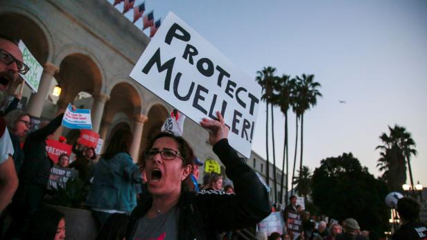 FILE PHOTO: People gather in front of City Hall to take part in a protest to protect the investigation led by Special Counsel Robert Mueller, in Los Angeles