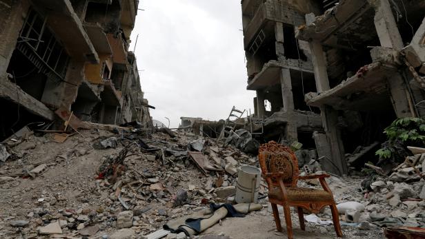 FILE PHOTO: A chair is seen amid devastation in al-Hajar al-Aswad