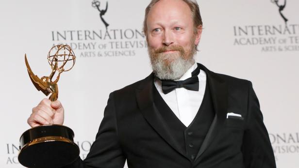 Danish actor Lars Mikkelsen poses with award for Performance by an Actor for his role in Herrens Veje (Ride Upon the Storm) at the International Emmy Awards in Manhattan, New York City