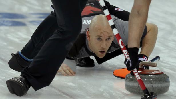 Canada's vice Ryan Fry looks down the sheet ahead of a stone during their men's curling semifinal game against China at the 2014 Sochi Olympics