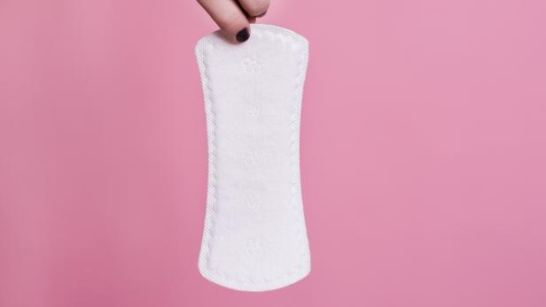 Women holding a sanitary napkin
