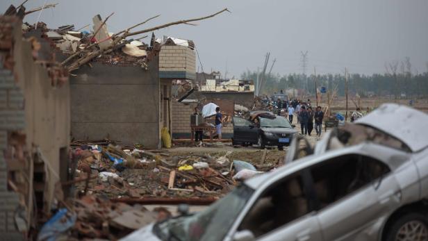 Nach einem Tornado liegen zerstörte Häuser und Autos in einem Dorf.