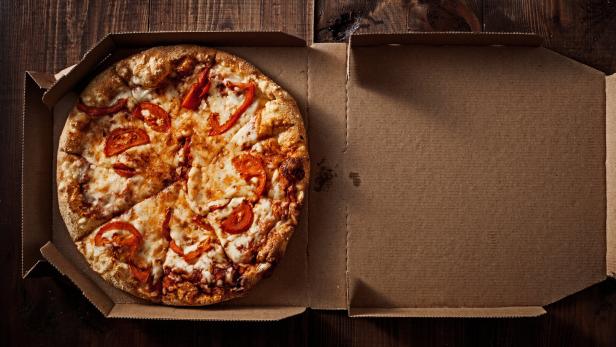 pizza in the in delivery box on the wood