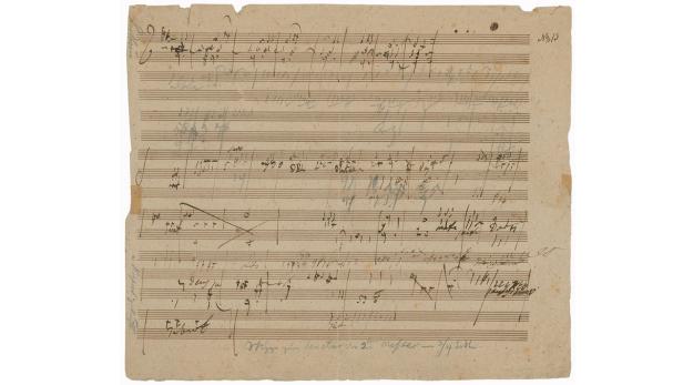 Ein Blatt mit handgeschriebenen Noten und Anmerkungen in deutscher Sprache.