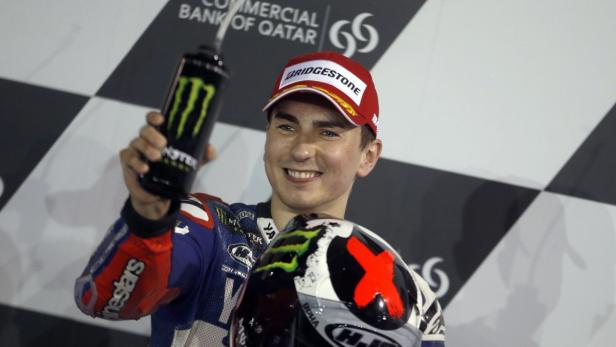 Yamaha MotoGP rider Jorge Lorenzo of Spain celebrates taking the pole position following the qualifying session of the Qatar MotoGP Grand Prix at the Losail International circuit in Doha April 6, 2013. REUTERS/Fadi Al-Assaad (QATAR - Tags: SPORT MOTORSPORT)