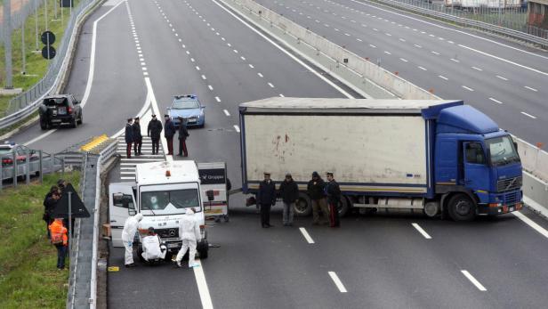 epa03653790 Forensic officers inspect a security van after it was raided by gunmen on the highway A9 near Turate, Italy, 08 April 2013. Robbers may have escaped with as much as 10 million euros&#039; worth of loot, according to initial reports, in a paramilitary-style raid on two armoured security vans near Milan on 08 April. Some 10 bandits blocked the A9 highway using smoke bombs to create the illusion a vehicle was ablaze at around 7am local time and then opened fire with Kalashnikovs to get the security guards to leave the vans. The robbers fled in three three cars. No injuries were reported. EPA/MATTEO BAZZI