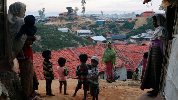 Rohingya refugee women and children look on at the Balukhali camp in Cox's Bazar