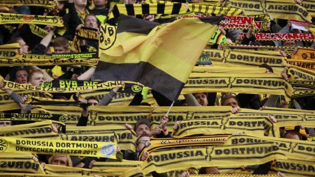 Borussia Dortmund fans cheer before the start of the German DFB Cup (DFB Pokal) final soccer match between Bayern Munich and Borussia Dortmund at the Olympic stadium in Berlin May 12, 2012. REUTERS/Ina Fassbender (GERMANY - Tags: SPORT SOCCER) DFB RULES PROHIBIT USE IN MMS SERVICES VIA HANDHELD DEVICES UNTIL TWO HOURS AFTER A MATCH AND ANY USAGE ON INTERNET OR ONLINE MEDIA SIMULATING VIDEO FOOTAGE DURING THE MATCH