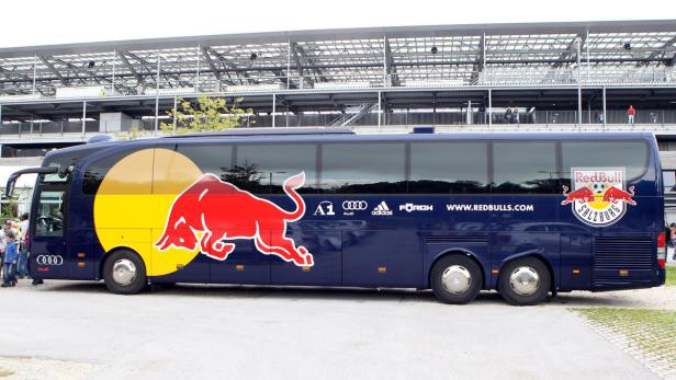 Ein Bus von Red Bull Salzburg mit dem Logo des Teams vor einem Stadion.