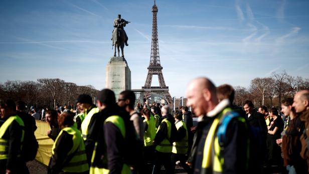 Protesters wearing yellow vests gather near the Eiffel tower during a demonstration by the "yellow vests" movement in Paris