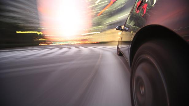 Ein Auto fährt mit hoher Geschwindigkeit durch die Stadt.