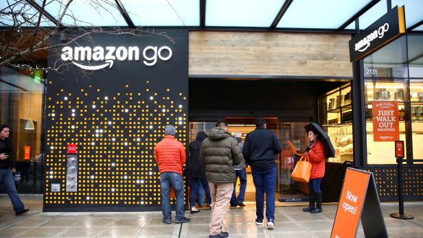 FILE PHOTO:    People are offered free reusable bags as they enter the new Amazon Go store in Seattle