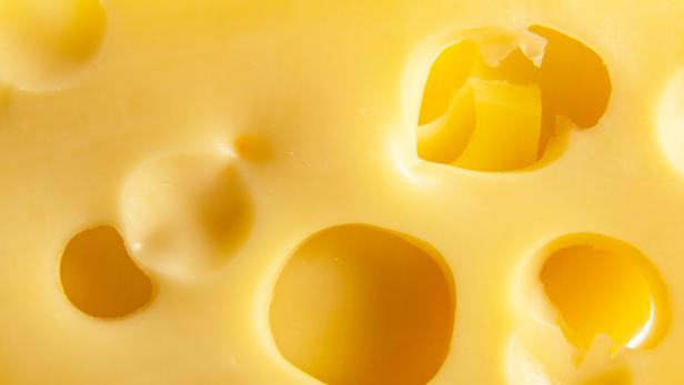 Photo of yellow cheese with holes
