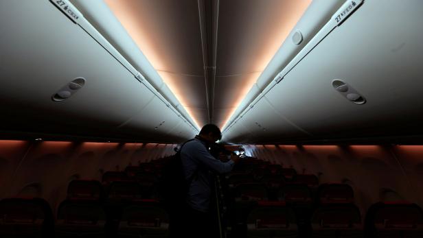 FILE PHOTO: A man takes pictures inside a Norwegian Air Boeing 737-800 during the presentation of Norwegian Air first low cost transatlantic flight service from Argentina at Ezeiza airport in Buenos Aires
