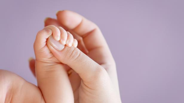 Newborn children's hand in mother hand. Mom and her Child.