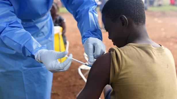 FILE PHOTO: A Congolese health worker administers Ebola vaccine to a boy who had contact with an Ebola sufferer in the village of Mangina
