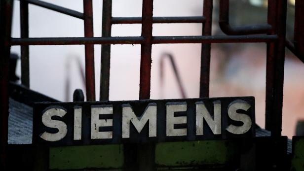 FILE PHOTO: A sign of Germany's industrial group Siemens AG is pictured at a primary rolling mill of Germany's largest steel factory of ThyssenKrupp Steel AG in Duisburg