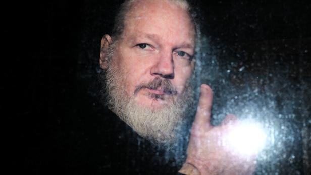 FILE PHOTO: WikiLeaks founder Julian Assange is seen as he leaves a police station in London