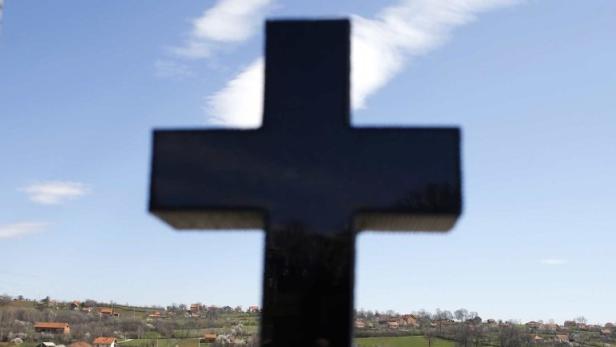 A gravestone is seen in the village of Velika Ivanca, about 40 km (25 miles) southwest of Belgrade April 10, 2013. A veteran of the 1990s Balkan wars shot dead 13 people, including his mother, son and a two-year-old child in a dawn rampage through Velika Ivanca in central Serbia on Tuesday, authorities said. The man, identified by police as Ljubisa Bogdanovic, also shot his wife before turning the gun on himself. Both were in critical condition in hospital, police said. REUTERS/Marko Djurica (SERBIA - Tags: CRIME LAW SOCIETY)