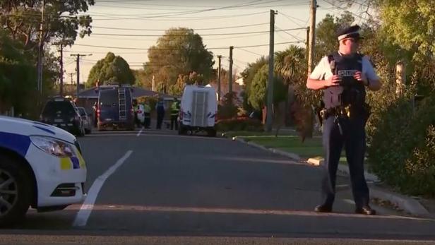 Police officers and vehicles are seen behind police cordon, in Christchurch, New Zealand in this still image taken from video