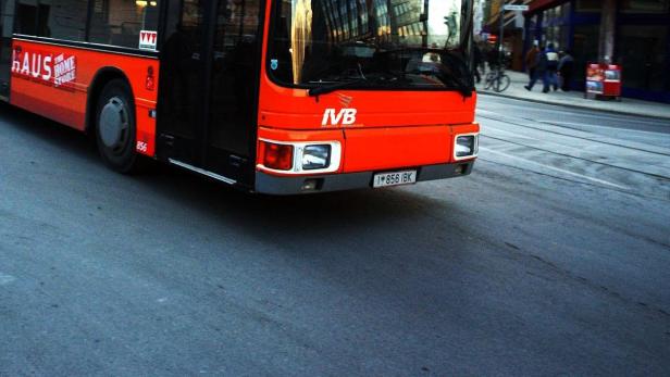 Ein roter Bus der IVB fährt durch eine Stadt.