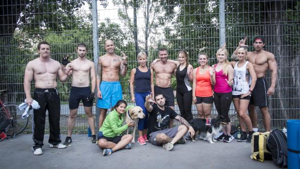Mit einem überkreuzten Mittel- und Zeigefinger drücken die österreichischen Freeletics-Sportler ihr Gemeinschaftsgefühl aus.