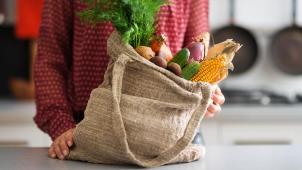 Closeup of burlap sac filled with autumn vegetables