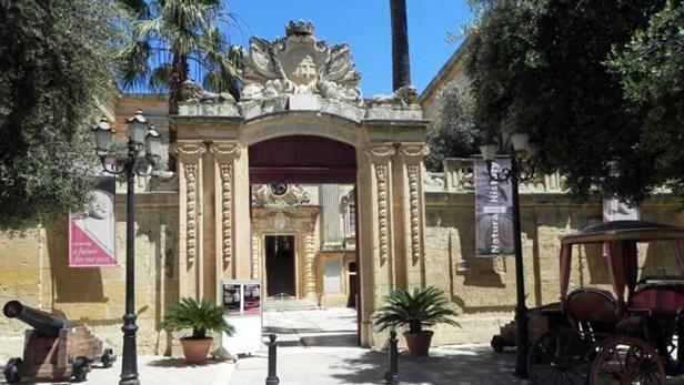 Ein verzierter Torbogen führt zu einem Gebäude mit Ausstellungen zur Naturgeschichte.