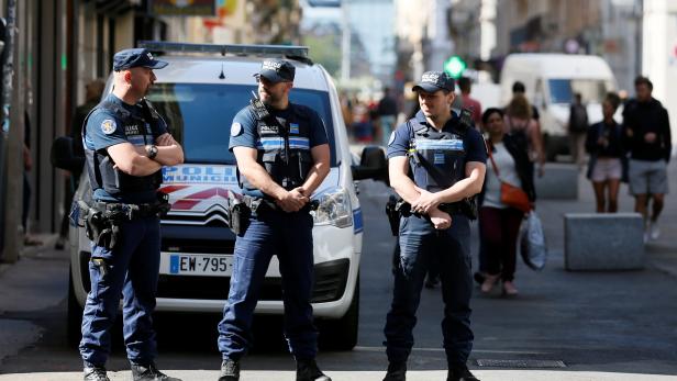Police patrol the streets during the manhunt of a suspected suitcase bomber in central Lyon