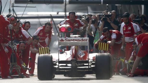 Crew members attend to Ferrari Formula One driver Felipe Massa of Brazil during the second practice session of the Chinese F1 Grand Prix at the Shanghai International circuit, April 12, 2013. REUTERS/Aly Song (CHINA - Tags: SPORT MOTORSPORT F1)