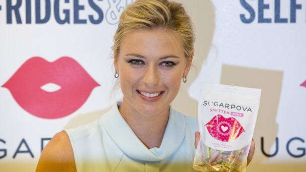 Tennis player Maria Sharapova poses for photographers as she promotes her &quot;Sugarpova&quot; confectionary brand in London June 20, 2013. REUTERS/Neil Hall (BRITAIN - Tags: BUSINESS FOOD SPORT TENNIS)