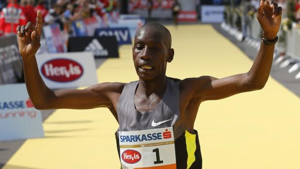 Henry Sugut from Kenya celebrates after winning the Vienna City Marathon in Vienna April 14, 2013. REUTERS/Leonhard Foeger (AUSTRIA - Tags: SPORT ATHLETICS)