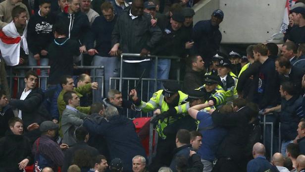 Millwall fans fight with police officers during their FA Cup semi-final soccer match against Wigan Athletic at Wembley Stadium in London, April 13, 2013. REUTERS/Darren Staples (BRITAIN - Tags: SPORT SOCCER)