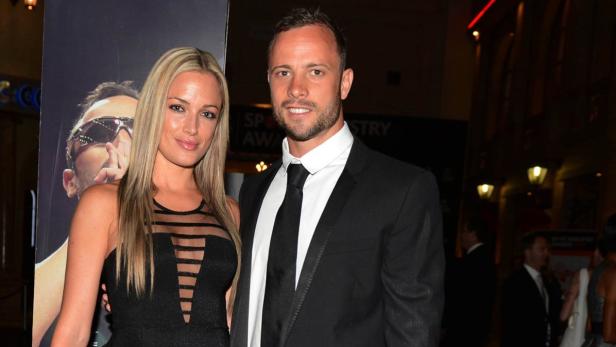 REFILE - CORRECTING BYLINE IN IPTC Oscar Pistorius (R) and his girlfriend Reeva Steenkamp pose for a picture in Johannesburg, February 7, 2013. South African &quot;Blade Runner&quot; Oscar Pistorius, a double amputee who became one of the biggest names in world athletics, was charged on February 14, with shooting dead his girlfriend at his home in Pretoria. Picture taken February 7, 2013. REUTERS/Thembani Makhubele (SOUTH AFRICA - Tags: CRIME LAW SPORT ATHLETICS TPX IMAGES OF THE DAY)