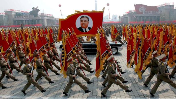 FILE PHOTO:North Korea's military personnel parade with a portrait of North Korea's late leader Kim Il-sung in central Pyongyang