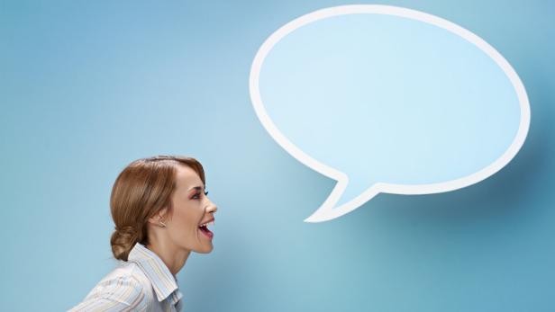 mid adult business woman screaming in blank speech bubble on blue background. Horizontal shape, side view, waist up, copy space