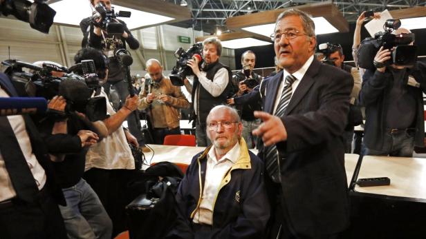 Jean-Claude Mas (C), founder of French company Poly Implant Prothese (PIP), is surrounded by journalists as he sits next to his lawyer Yves Haddad (R) at the courthouse before the start of the trial of PIP breast implant company in Marseille, April 17, 2013. With over 5,000 plaintiffs, 300 lawyers and five defendants, a high profile fraud case over substandard French breast implants that stoked a global health scare went to trial on Wednesday. More than 300,000 women around the world bought breast implants over a decade from French company PIP, whose founder has admitted filling them with a homemade recipe using industrial-grade silicone gel. REUTERS/Philippe Laurenson (FRANCE - Tags: CRIME LAW HEALTH MEDIA)